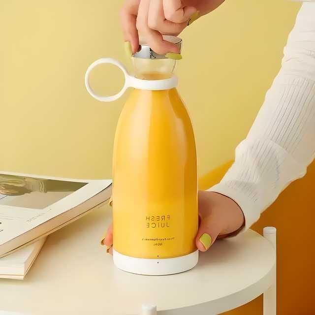 Yellow juice bottle with a person opening it against a yellow background
