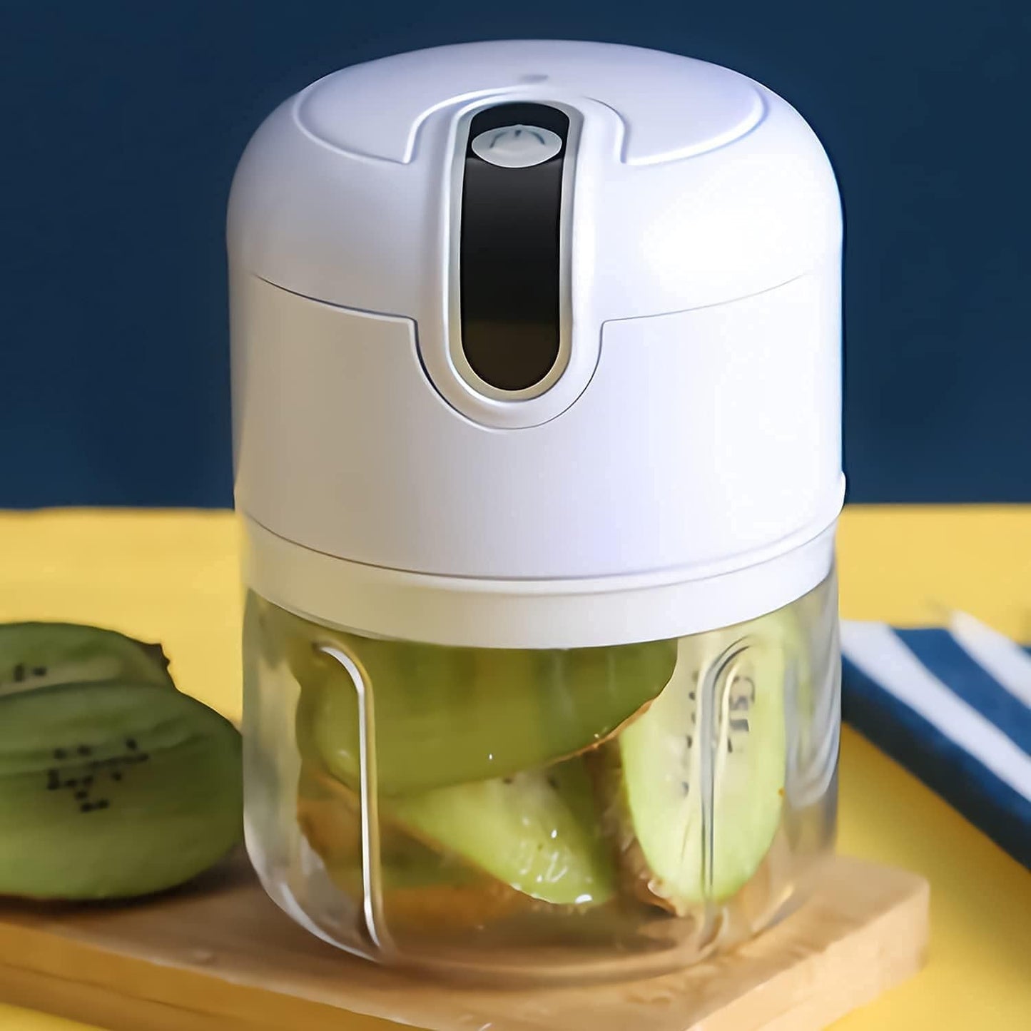 Small food processor with sliced kiwis on a wooden board