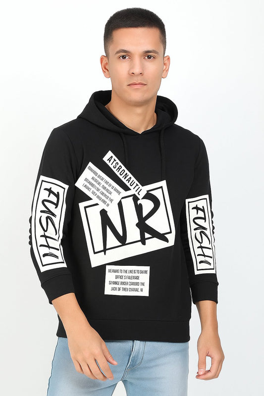 Person wearing a black hoodie with white text and graphics on a light gray background