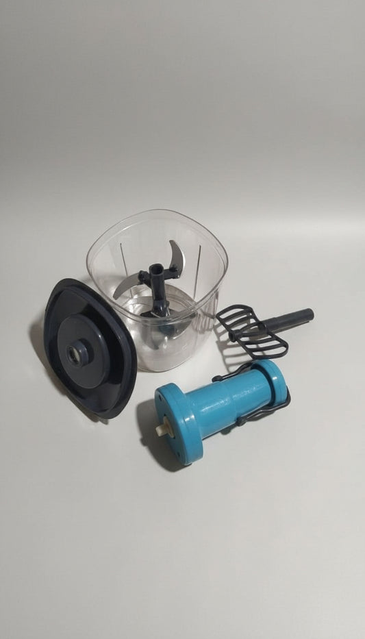 Blender parts including a blue base, clear container, and black lid on a white paper background.