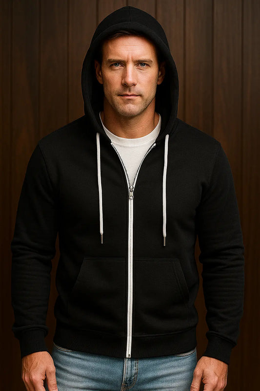 Man wearing a black hoodie with a zipper against a wooden background